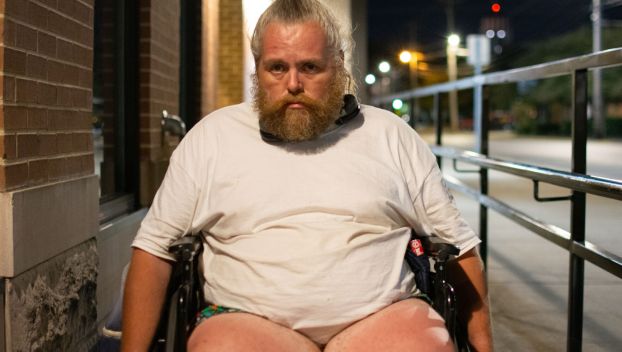 James Orrock, who recently lost his home after being evicted, sits in his wheelchair beside a building in downtown Bowling Green on Sept. 7.