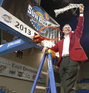 At the time Western's president, Gary Ransdell stands atop a ladder and waves a basketball hoop net following WKU’s victory at the 2013 Sun Belt Conference basketball tournament in Hot Springs, Arkansas.